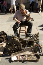 One man band busker musician, Abbey churchyard, Bath, Somerset, England, UK