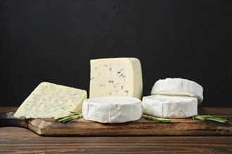 Wooden platter with assortment of white cheeses