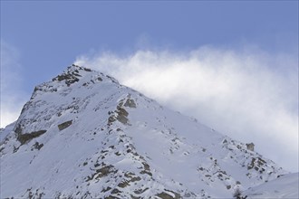 Snow covered mountain top, pinnacle Cima dell'Arolley in winter in the Gran Paradiso Massif of the