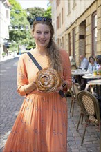 Swedish woman, 39 years old, with a traditional cinnamon bun, Haga neighbourhood, Gothenburg,