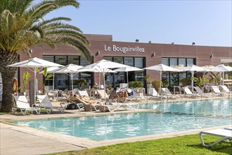 Tourists at swimming pool, Radisson Blu Resort, Taghazout Bay Surf Village, Taghazout, Morocco,