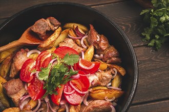 Ojakhuri, Traditional Georgian dish, fried potatoes with meat, in a clay frying pan, top view, no