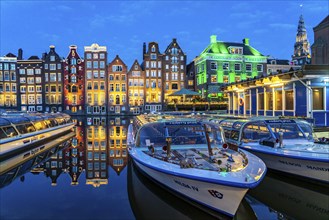 Canal houses on the Damrak, in the centre of the old town of Amsterdam, harbour, starting point of