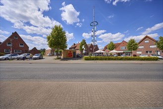 Maypole with residential and commercial buildings on Haltener Strasse in the Hausdülmen district,