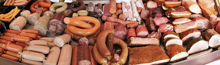 Panoramic picture of a sausage counter in a butcher's shop