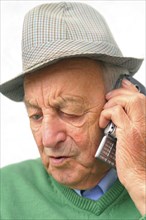 A senior citizen talking on his smartphone, mobile phone, mobile phone, 65 years old, studio