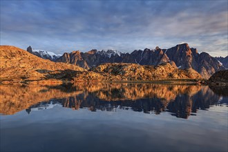 Mountains and rocks reflected in fjord, midnight sun, mood, Scoresby Sound, East Greenland,