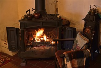 Europe, Germany, fireplace, stove, type Franklin, in living room, chair by the fireplace, Hamburg,