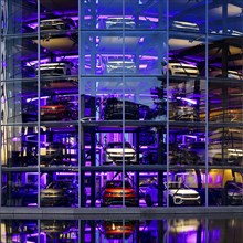 An illuminated car tower with new cars for delivery in the evening, detail, Autostadt, Volkswagen