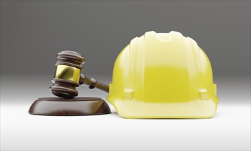 Yellow hard hat and gavel on a gradated background