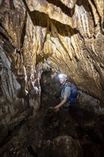 Man exploring stalactite cave, Terciopelo Cave, Barra Honda National Park, Costa Rica, Central