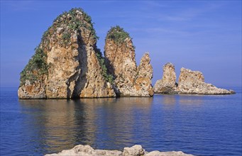 Limestone rock stacks stand in blue Tyrrhenian sea, Scopello, Sicily, Italy, Europe