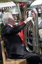 Musicians in a brass band perform during a country fair at Helmingham Hall, Suffolk, England,