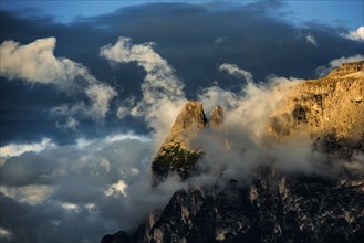 Sunset and mountain peaks in the clouds, Catinaccio, Dolomites, South Tyrol, Trentino-Alto Adige,