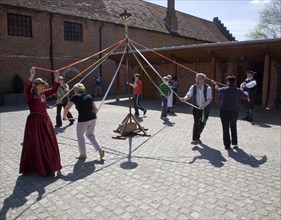 People maypole dancing during Tudor history re-enactment day, Layer Marney Tower, Essex, England,