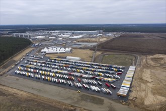 View of the Tesla Giga Factory site, with containers and swap trailers in the foreground,