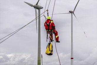 Height rescuers from the Oberhausen fire brigade practise abseiling from a wind turbine from a