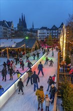 Ice rink at the Christmas market on the Heumarkt in the old town of Cologne, Cologne Cathedral,