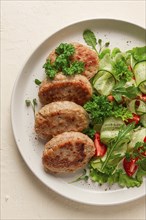 Fried cutlets, turkey, with vegetable salad, top view, no people