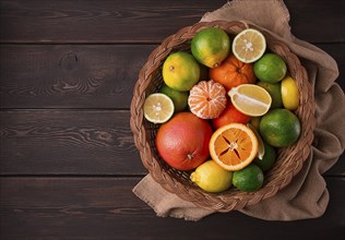 Assortment, citrus fruits, in a basket, close-up, top view, no people