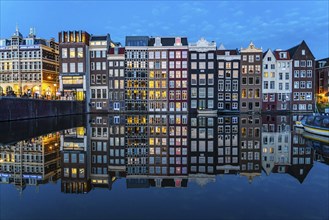 Canal houses on the Damrak, in the centre of the old town of Amsterdam, harbour, starting point of