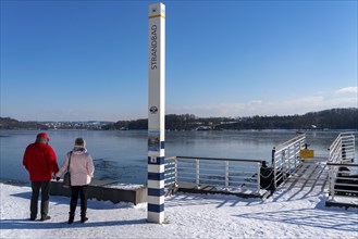 Winter in the Ruhr area, Lake Baldeney, snow-covered, partly frozen lake, shore, pier Strandbad,