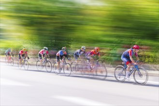 Racing cyclists in a fast race on a sunny road, Stuttgart, Baden-Württemberg, Germany, Europe