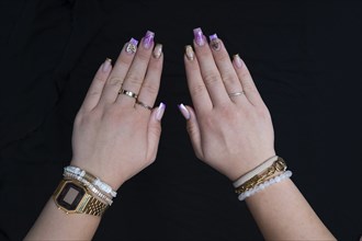 Colourful fingernails of a young woman, on a black background, Baden-Württemberg, Germany, Europe