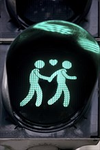 Green pedestrian traffic light with two men and heart, male traffic light couple, homosexual love,