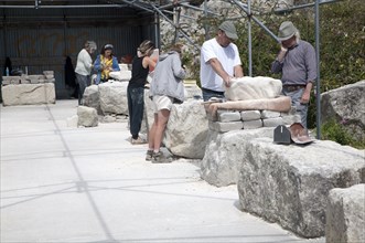 Sculptors working on local Portland stone in a community open air studio space at Tout Quarry, Isle