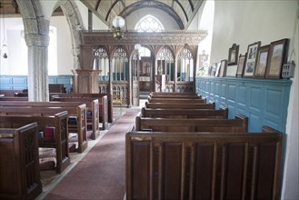 Wooden pews and rood screen of small village church of Saint Peter, Buckland in the Moor, Dartmoor