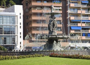 Water fountain by modern apartment buildings in the city of Malaga, Spain, Europe