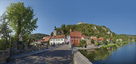 Bridge with the statue of St Nepomuk over the river Naab in a peaceful atmosphere with a view of