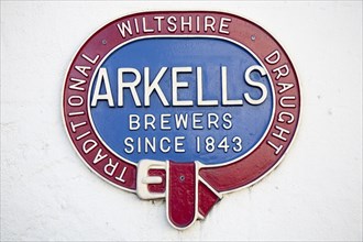 Close up of old metal advertising sign for Arkells brewers of traditional draught beer since 1843,