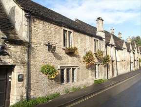 A row of attractive stone cottages in Castle Combe, Wiltshire, England, UK claimed to be England's