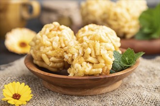 Traditional Tatar candy chak-chak made of dough and honey with cup of coffee on a black concrete