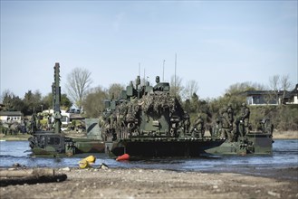 Pandur wheeled tanks of the Czech army drive onto German Bundeswehr vehicles of the Amphibie M3