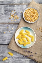 Jelly corn candies on gray wooden background and linen textile. close up, top view, flat lay