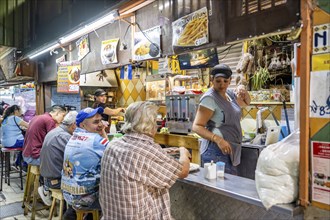 Visitors sitting at a food stall at the counter, Mercado Central de San José, San José, Costa Rica,