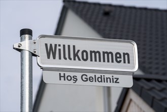 Street sign, Welcome, in German and Turkish, New residential neighbourhood with 150 plots, on the