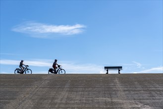 North Sea dyke near Westkapelle, cyclist on the Zeeuwse Wind Route cycle path, province of Zeeland,