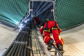 Height rescuers from the Oberhausen professional fire brigade practise abseiling from a wind