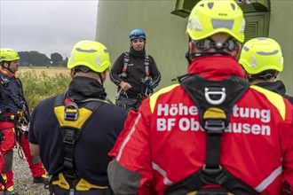 Height rescuers from the Oberhausen fire brigade practise abseiling from a wind turbine from a