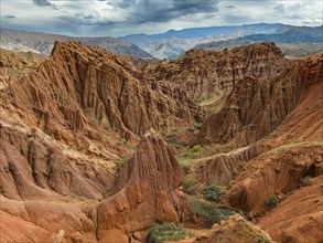 Eroded mountain landscape, canyon with red and orange rock formations, aerial view, Konorchek