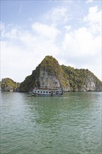 Excursion boat and the karst rocks in Lan Ha Bay, Halong Bay, Vietnam, Asia