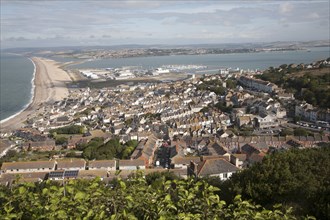 Chesil beach tombolo with high density housing in Fortuneswell, isle of Portland, Dorset, England,