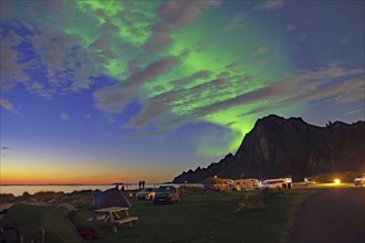 Sunset mingles with northern lights (aurora borealis), tents and caravans, Bleik, Langöya,