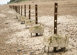 Remains of steel stanchions for barbed wire anti-invasion defences on beach at Bawdsey, Suffolk,