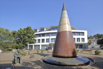 Pointed round pyramid and sculpture with monument to the town's history of the mineral water