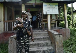 Security personnel keep vigil outside the office of National Register of Citizens (NRC) in the eve